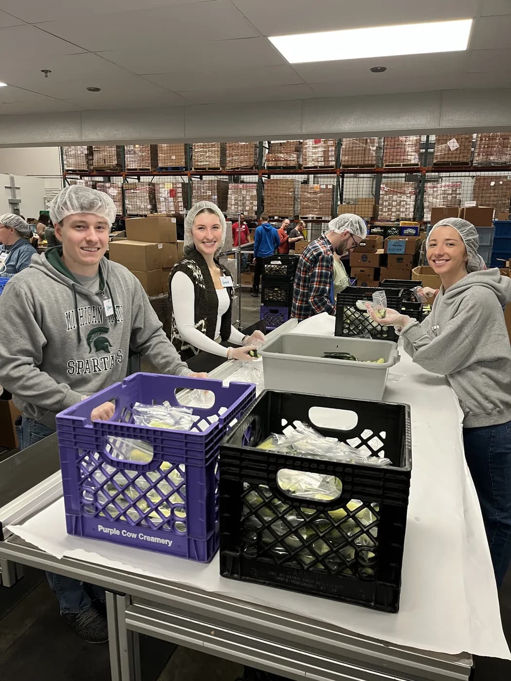 The Bloom Social team packing meals at Kids' Food Basket in Grand Rapids