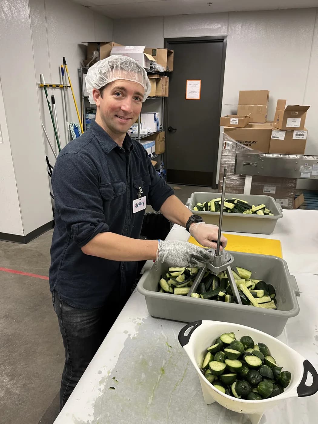 Jeff Pipp preparing fresh produce during a Bloom Social volunteer shift at Kids' Food Basket